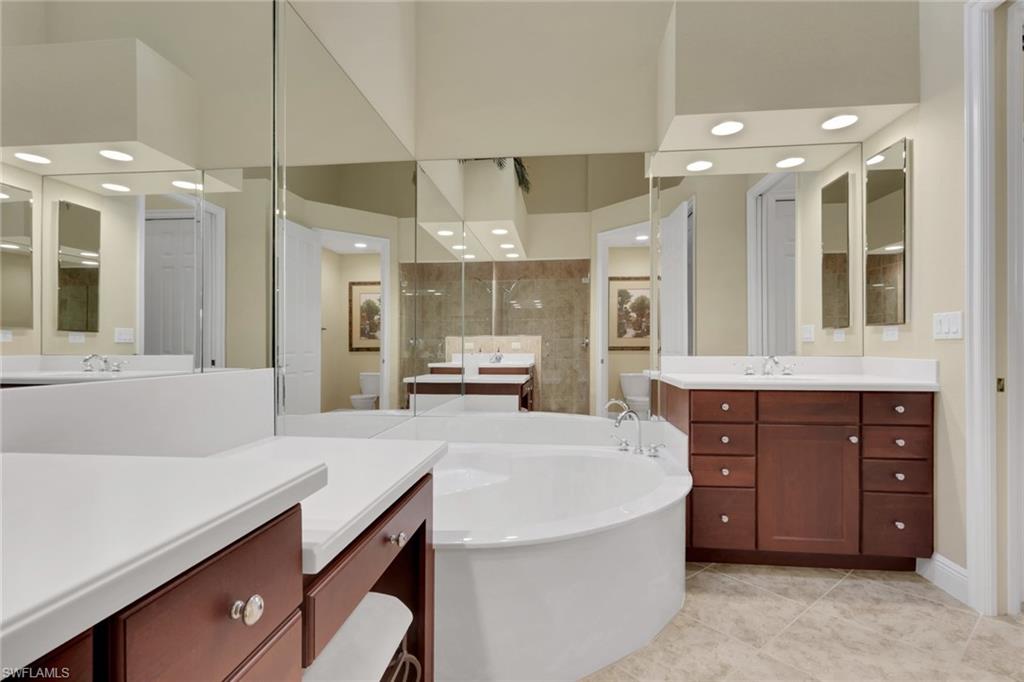 6397 Legacy Circle, Unit 2003 Naples, FL 34113 - Photo 24 of 26 a large kitchen with kitchen island a stove a sink and a refrigerator