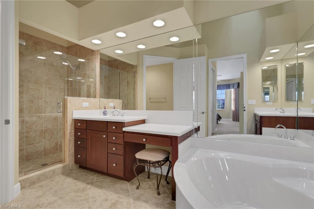 6397 Legacy Circle, Unit 2003 Naples, FL 34113 - Photo 25 of 26 a spacious bathroom with a sink double vanity and a mirror
