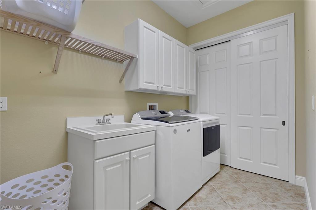 6397 Legacy Circle, Unit 2003 Naples, FL 34113 - Photo 26 of 26 a utility room with sink dryer and washer