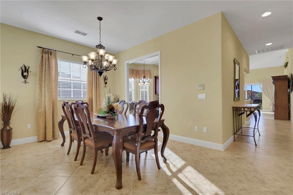 6397 Legacy Circle, Unit 2003 Naples, FL 34113 - Photo 6 of 26 a view of a dining room with furniture and chandelier