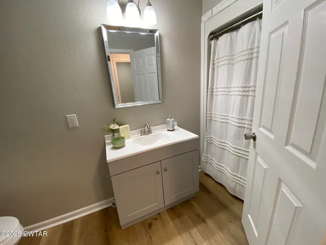 a bathroom with a sink vanity and a mirror