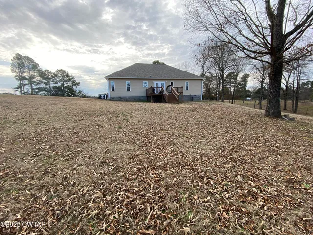 a front view of house with a garden