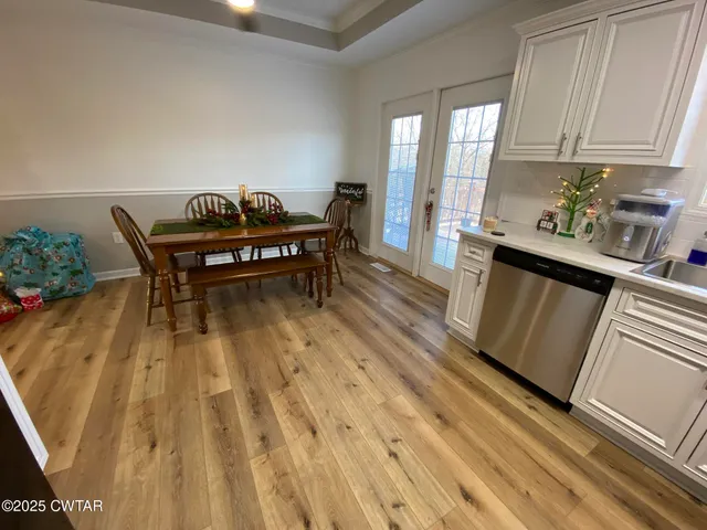 a living room with a couch wooden floor and a table