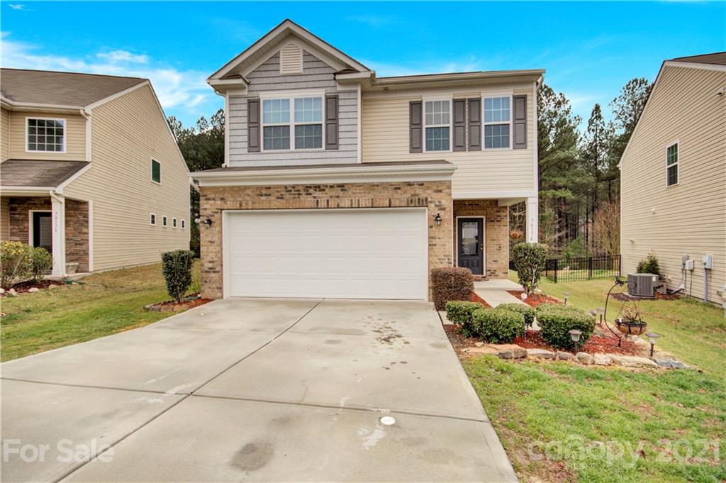 78174 Rillstone Drive Lancaster, SC 29720 - Photo 1 of 33 a front view of a house with a garden and plants