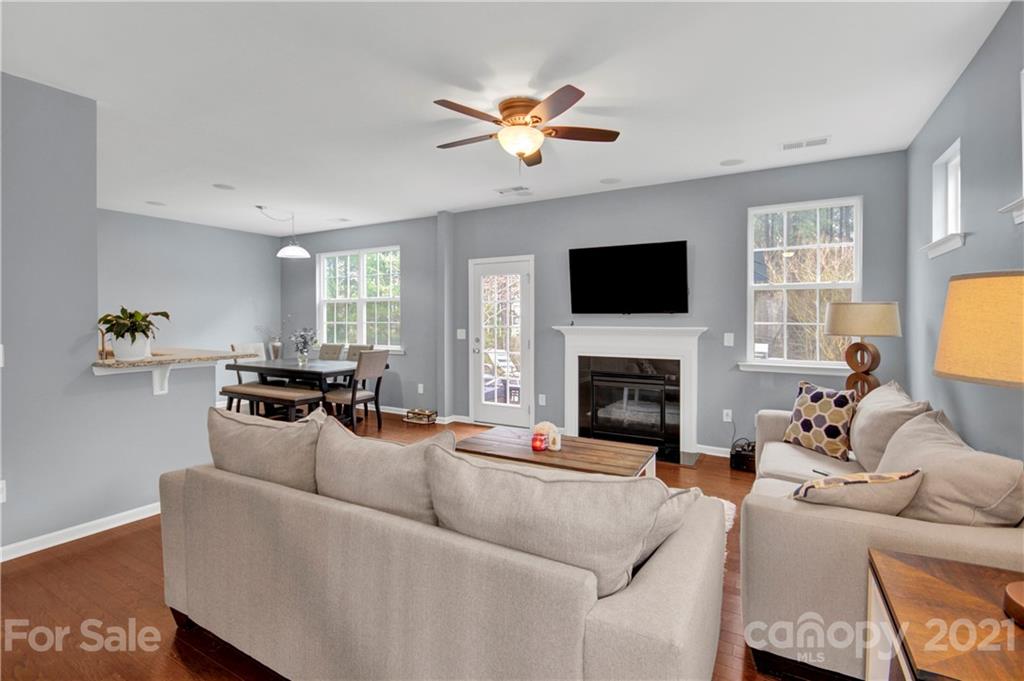 78174 Rillstone Drive Lancaster, SC 29720 - Photo 6 of 33 a living room with furniture a fireplace and a flat screen tv