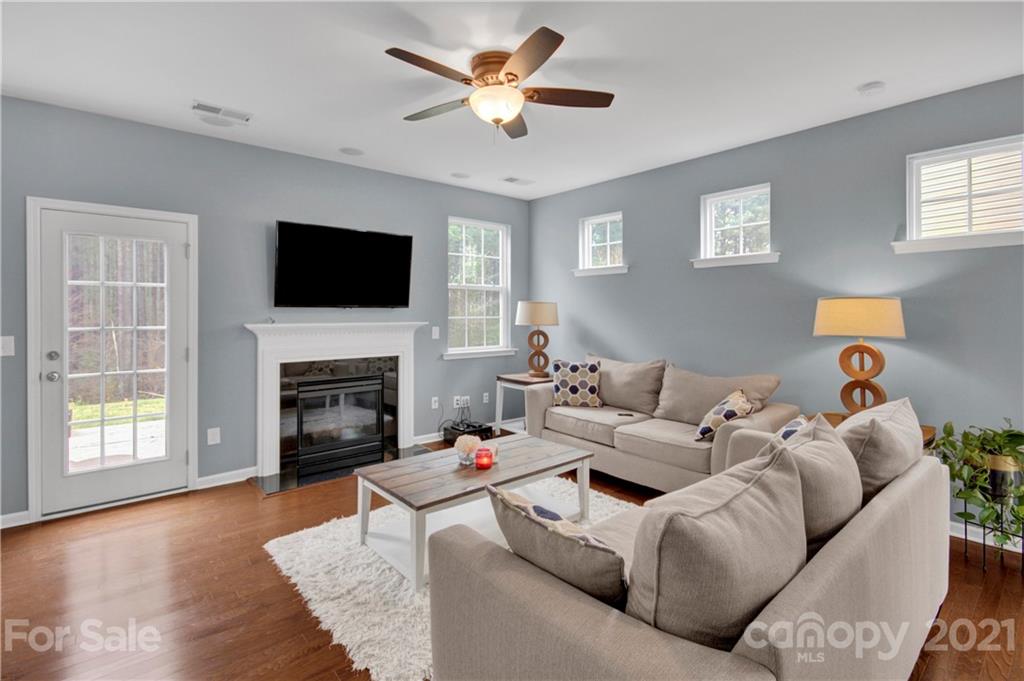 78174 Rillstone Drive Lancaster, SC 29720 - Photo 7 of 33 a living room with furniture a fireplace and a flat screen tv