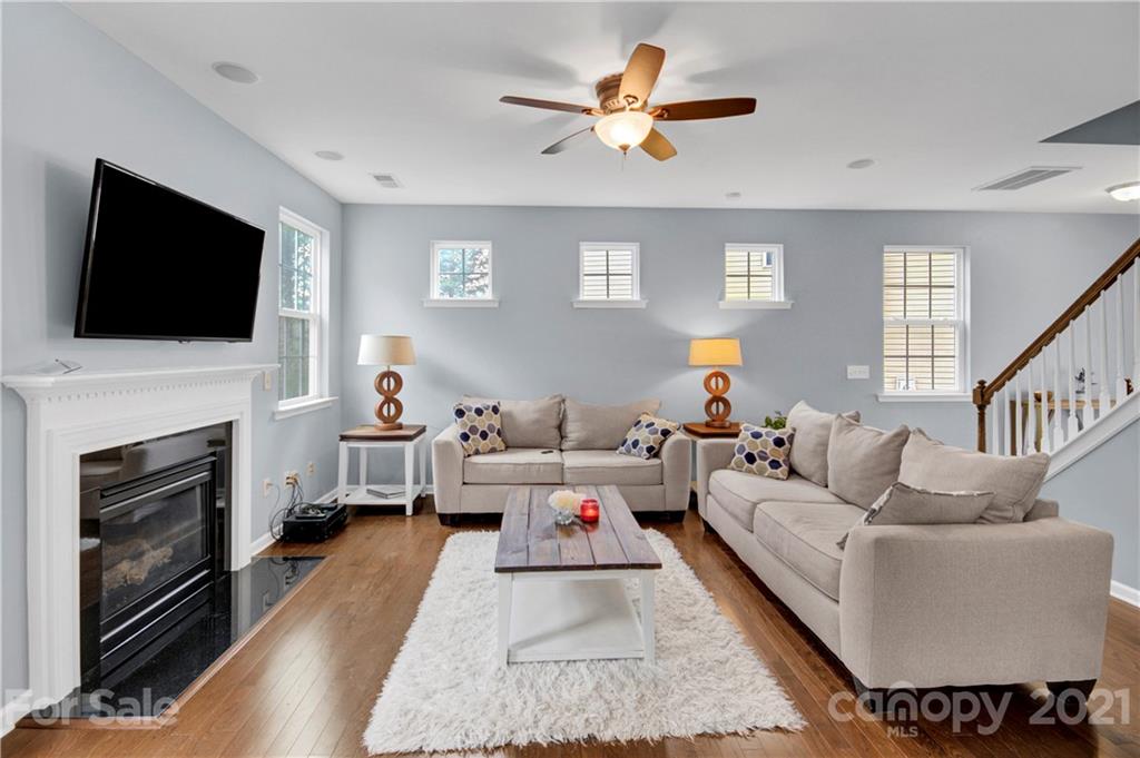 78174 Rillstone Drive Lancaster, SC 29720 - Photo 8 of 33 a living room with furniture a fireplace and a flat screen tv
