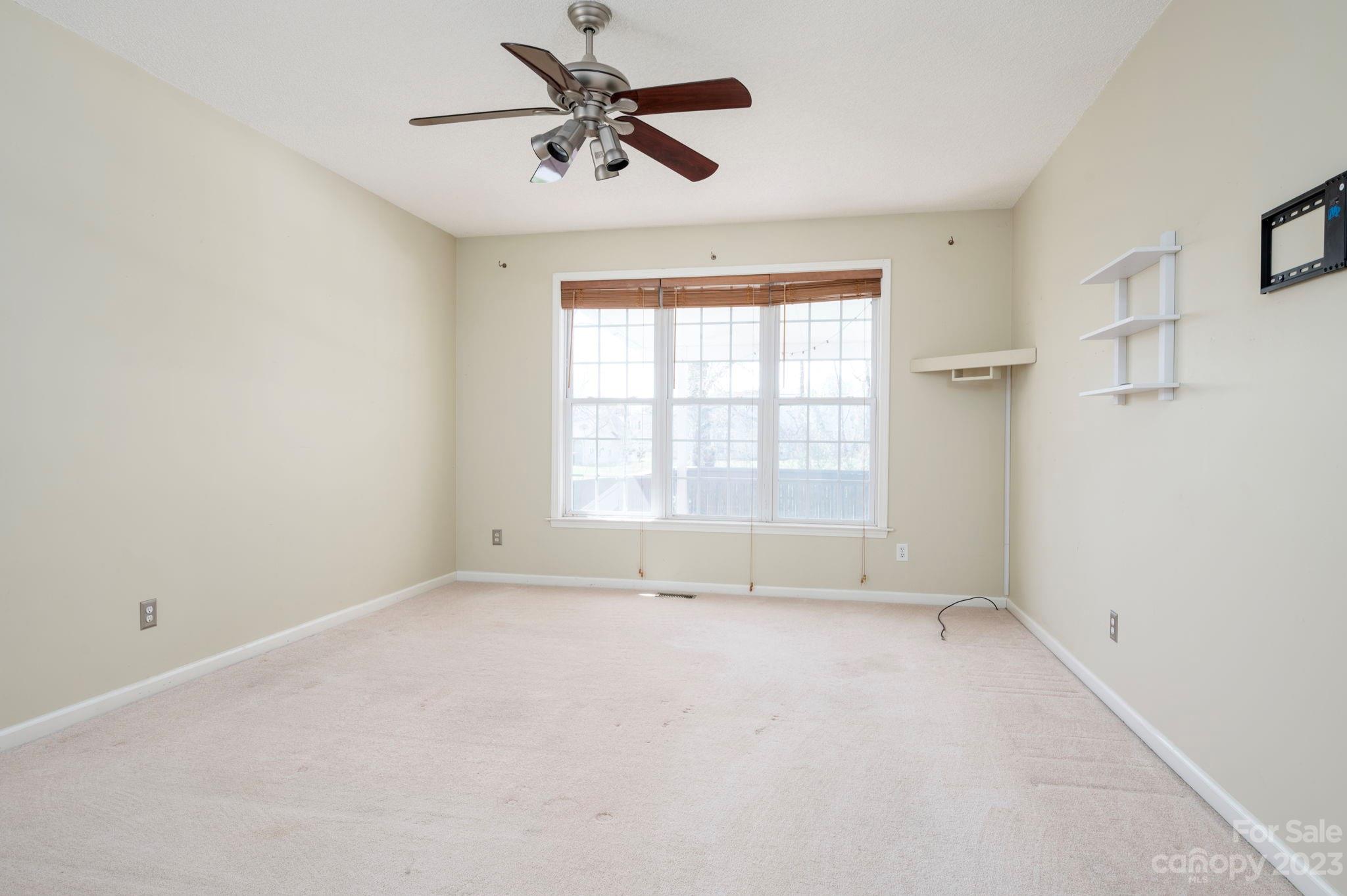 202 Walnut Crest Road Fletcher, NC 28732 - Photo 15 of 36 an empty room with a window and a fan