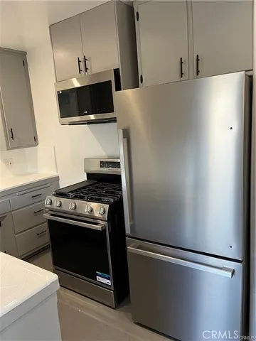 a kitchen with stainless steel appliances a refrigerator a stove and a sink