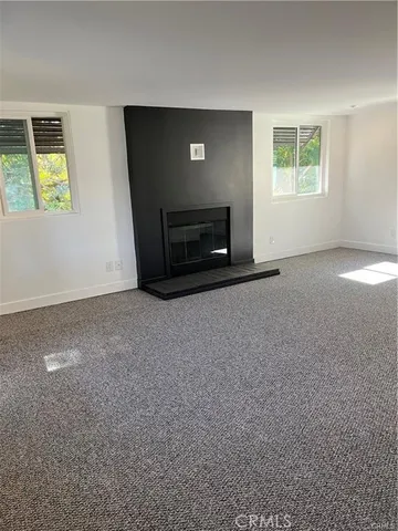 a view of empty room with a fireplace