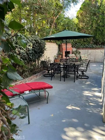 an outdoor space with furniture and umbrella