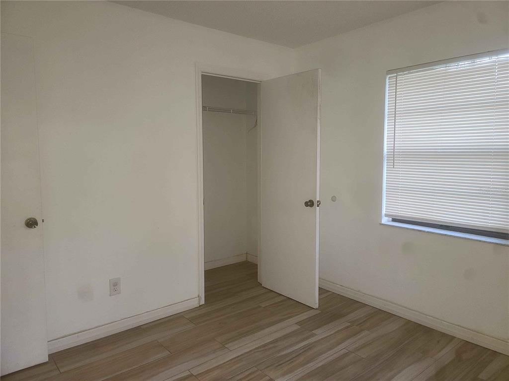 1187 Varnado Road Groveland, FL 34736 - Photo 11 of 25 an empty room with wooden floor and windows