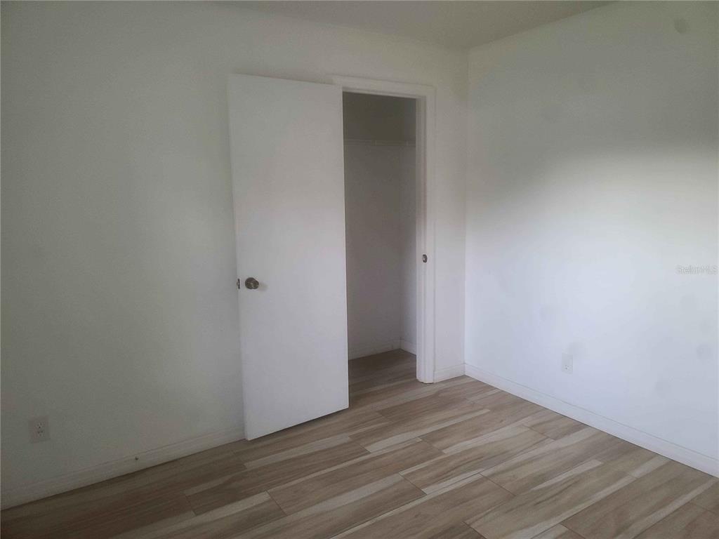 1187 Varnado Road Groveland, FL 34736 - Photo 12 of 25 an empty room with wooden floor