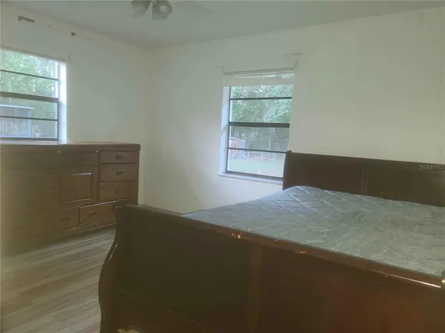 a bed sitting in a bedroom next to a window