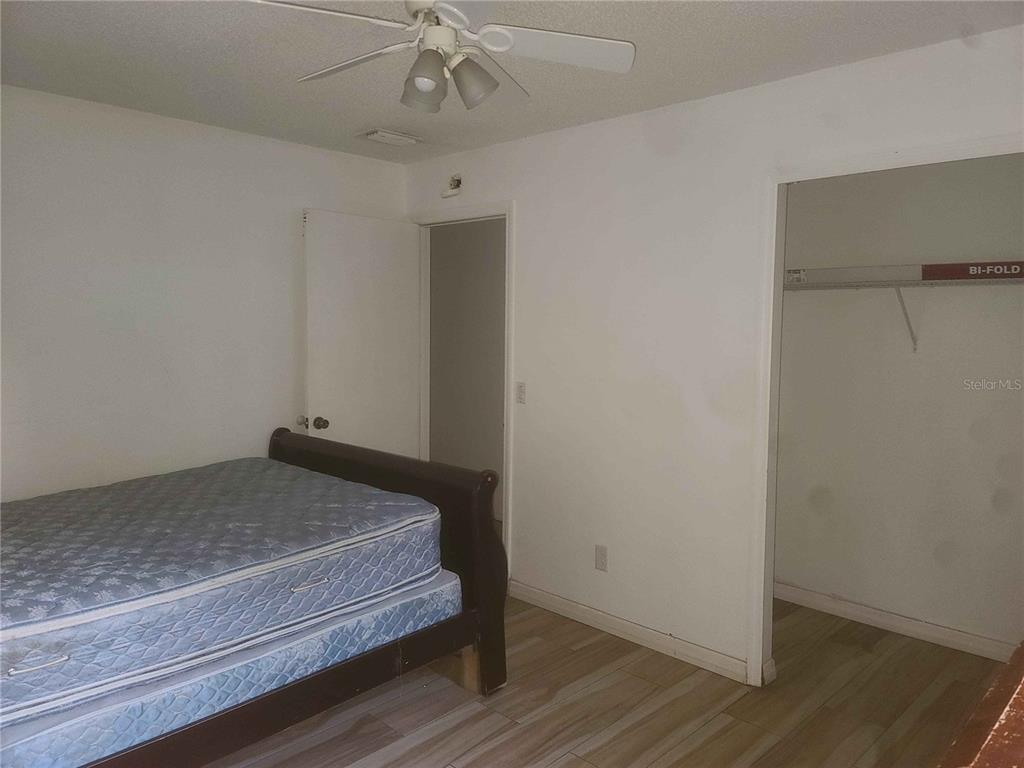 1187 Varnado Road Groveland, FL 34736 - Photo 15 of 25 a bedroom with a bed and wooden floor