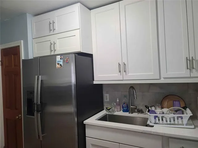 a kitchen with appliances cabinets and a counter top space