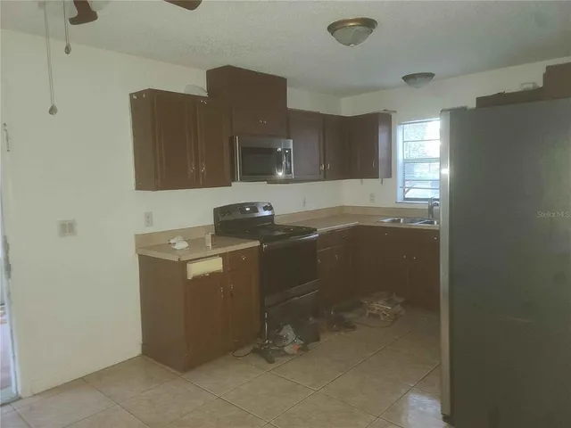 a utility room with cabinets washer and dryer