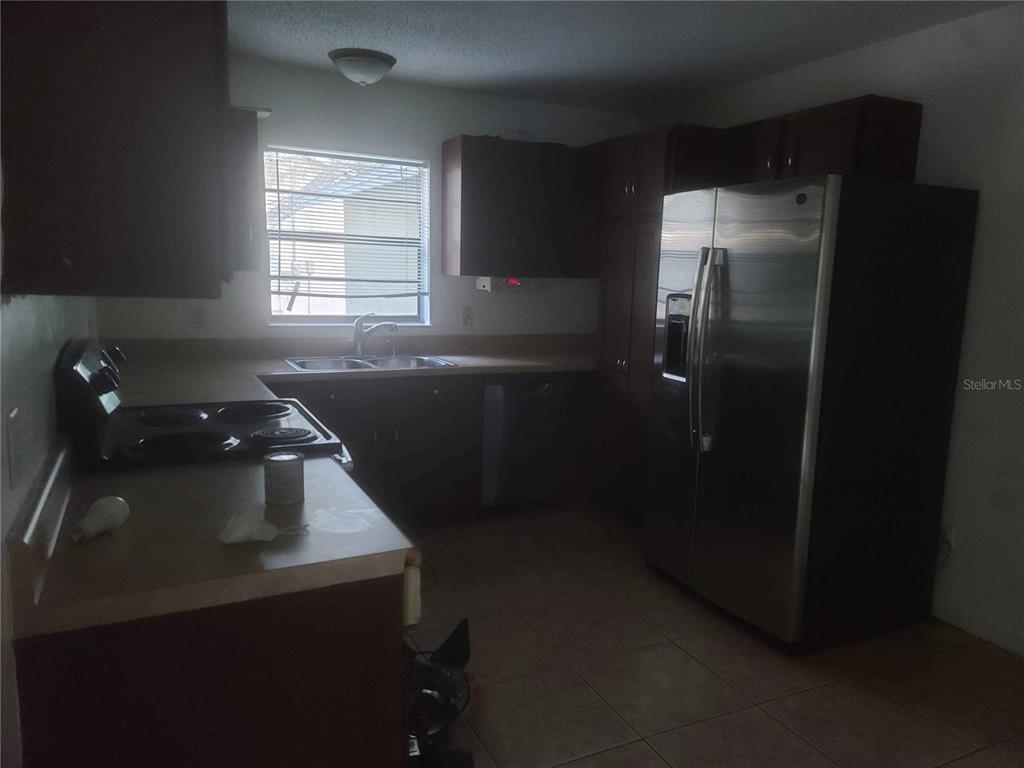 1187 Varnado Road Groveland, FL 34736 - Photo 6 of 25 a kitchen with a sink and cabinets