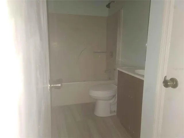 a white toilet sitting next to a white sink