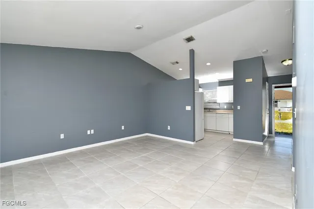 a view of a hallway with wooden floor and a bedroom