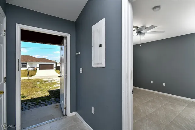 an empty room with windows and fan