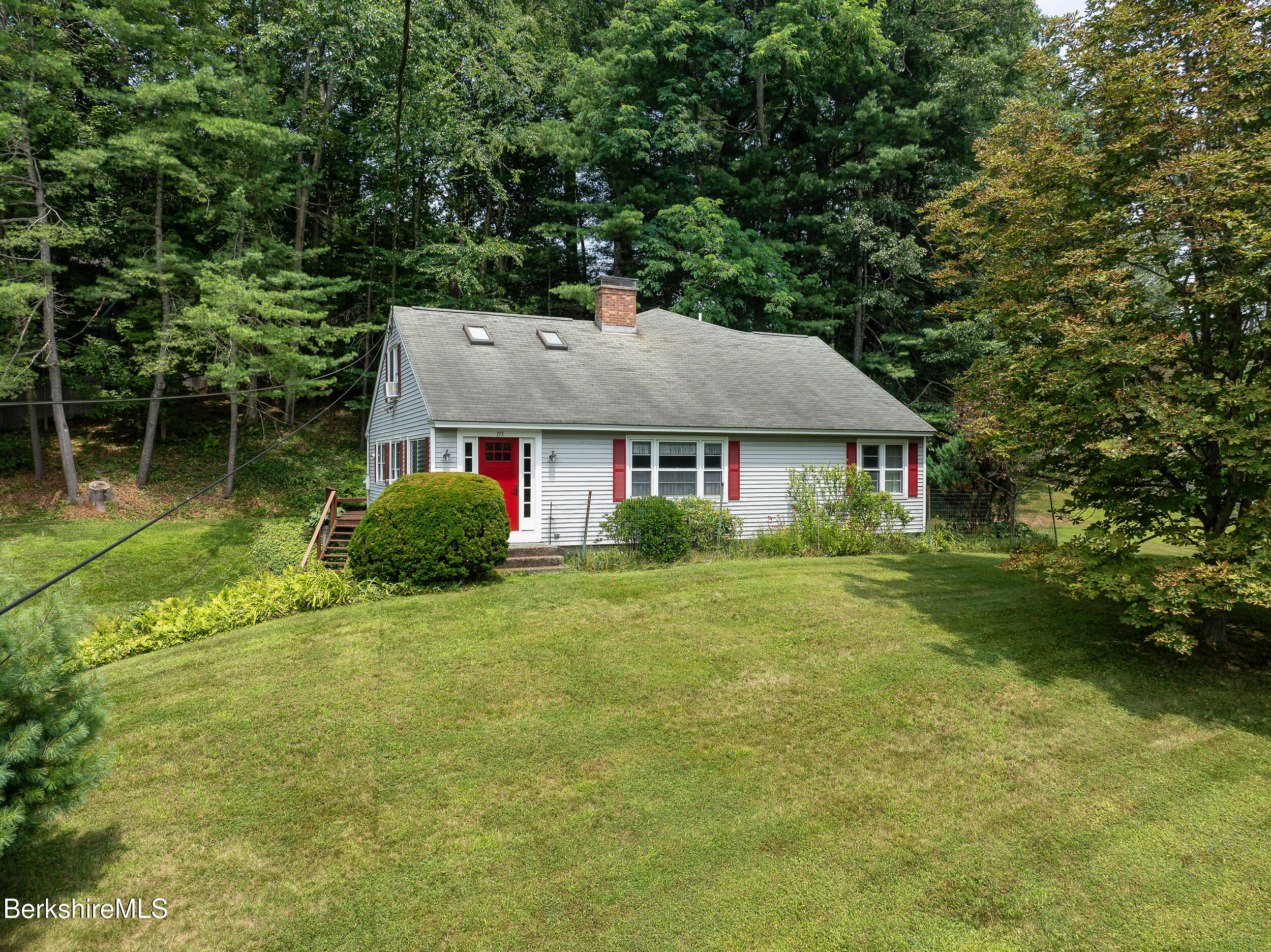 a aerial view of a house with swimming pool next to a yard