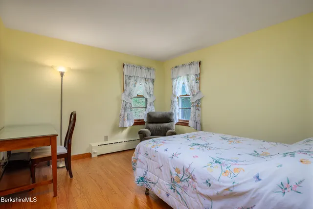 a bedroom with a bed a table and chair