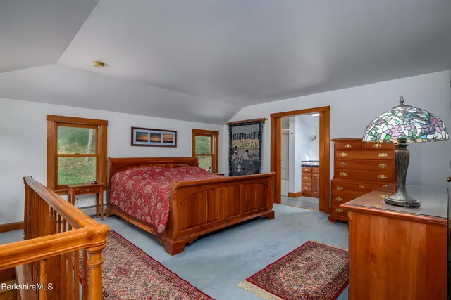 a bedroom with a bed window and a dresser
