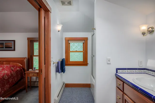 a view of bedroom with a bed and a window