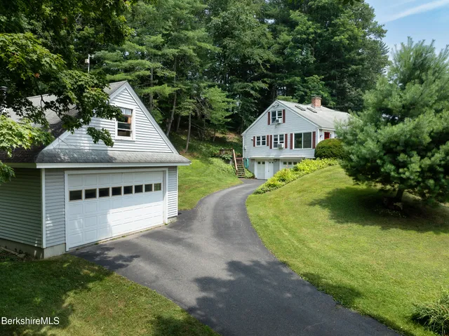 a view of house with outdoor space and trees around