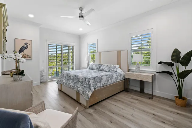 a bedroom with a bed and a lamp with wooden floor