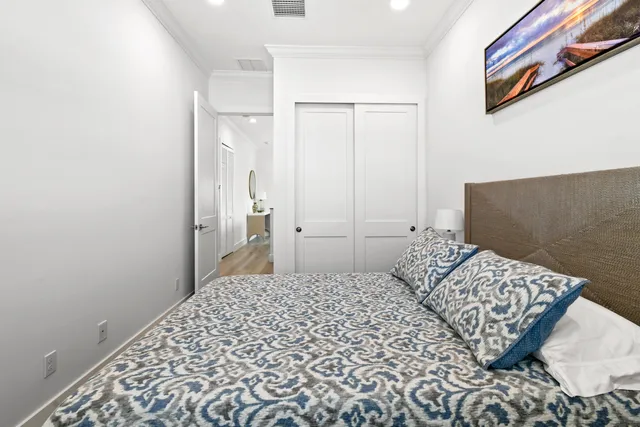 a front view of a house with a yard and potted plants