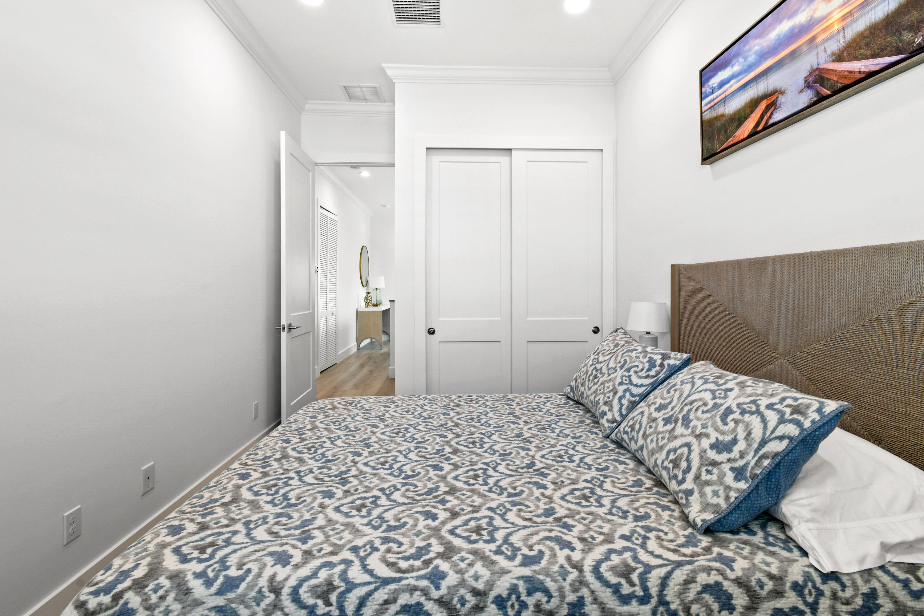 4650 Southeast Manatee Terrace Stuart, FL 34997 - Photo 33 of 95 a bedroom with a bed and a painting on the wall