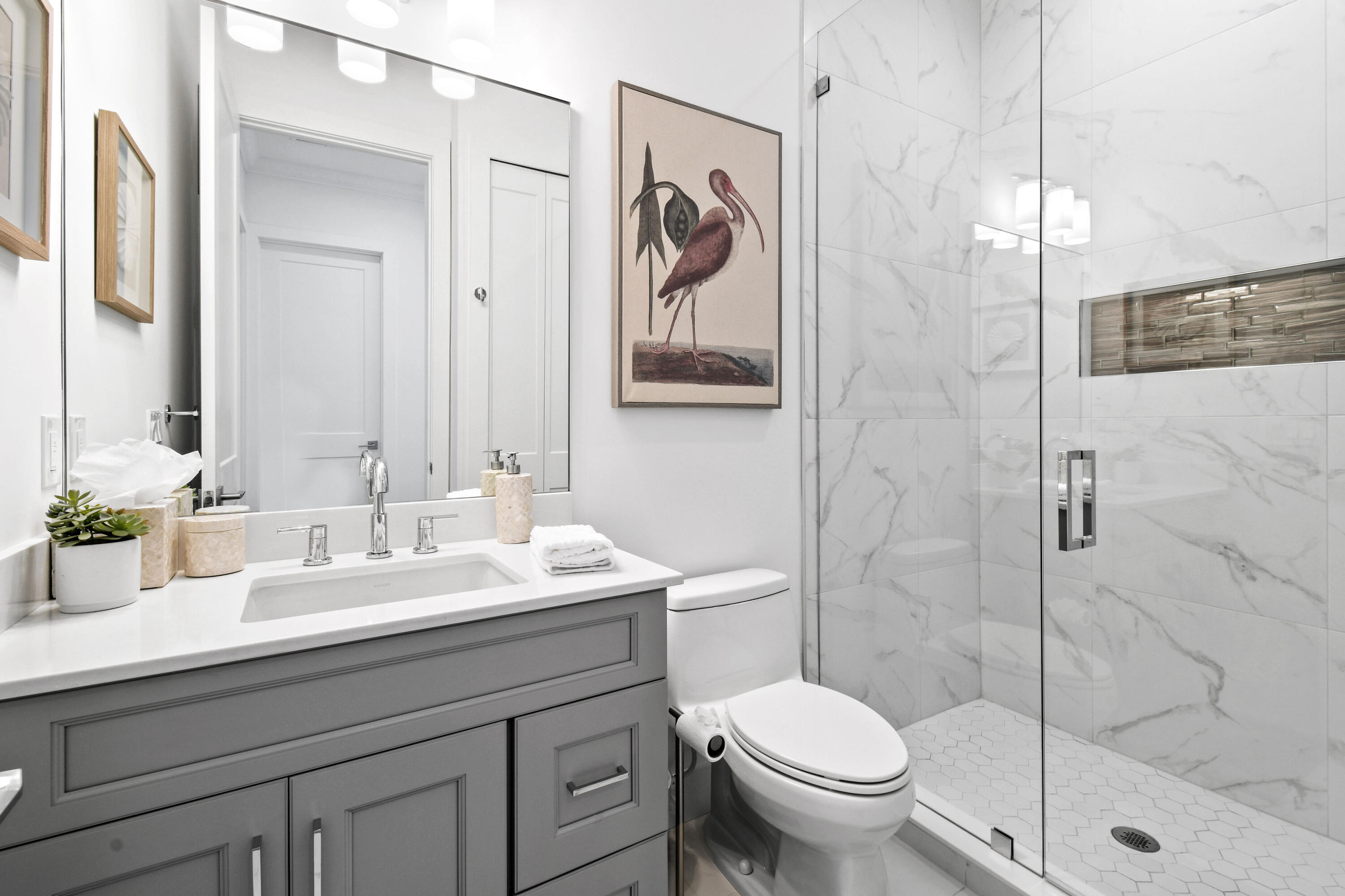 4650 Southeast Manatee Terrace Stuart, FL 34997 - Photo 34 of 95 a bathroom with a toilet sink and mirror