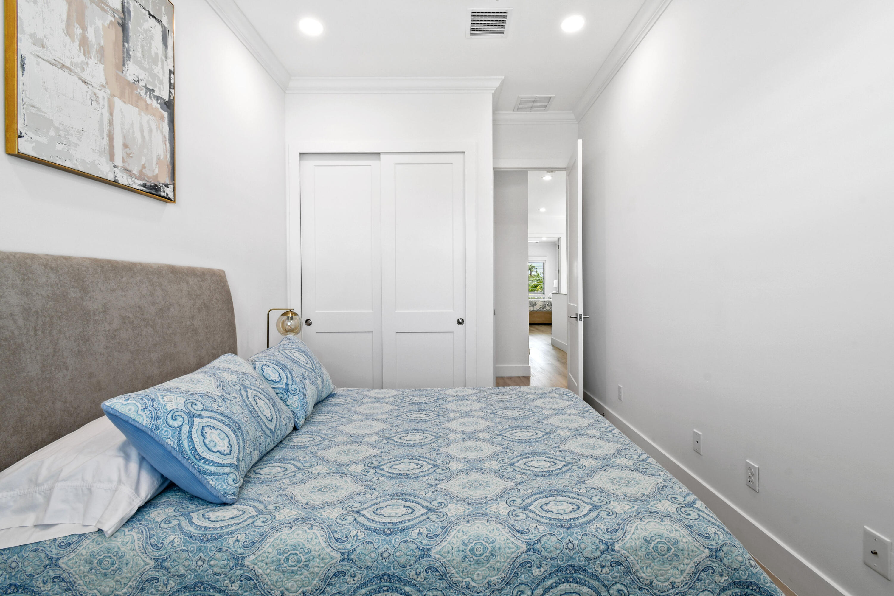 4650 Southeast Manatee Terrace Stuart, FL 34997 - Photo 36 of 95 a bedroom with a bed and a painting on the wall