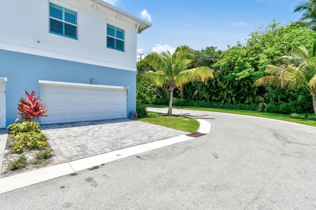 an aerial view of residential houses with outdoor space and swimming pool