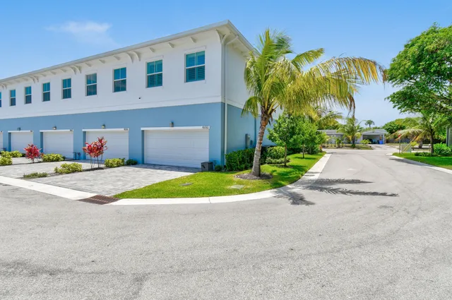 an aerial view of residential houses with outdoor space and swimming pool