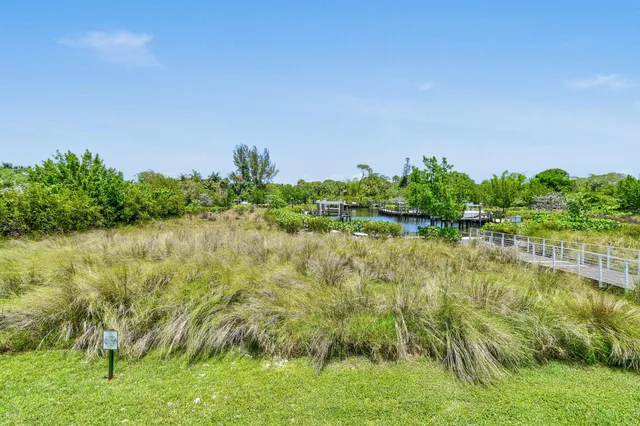 an aerial view of a house with a garden and lake view