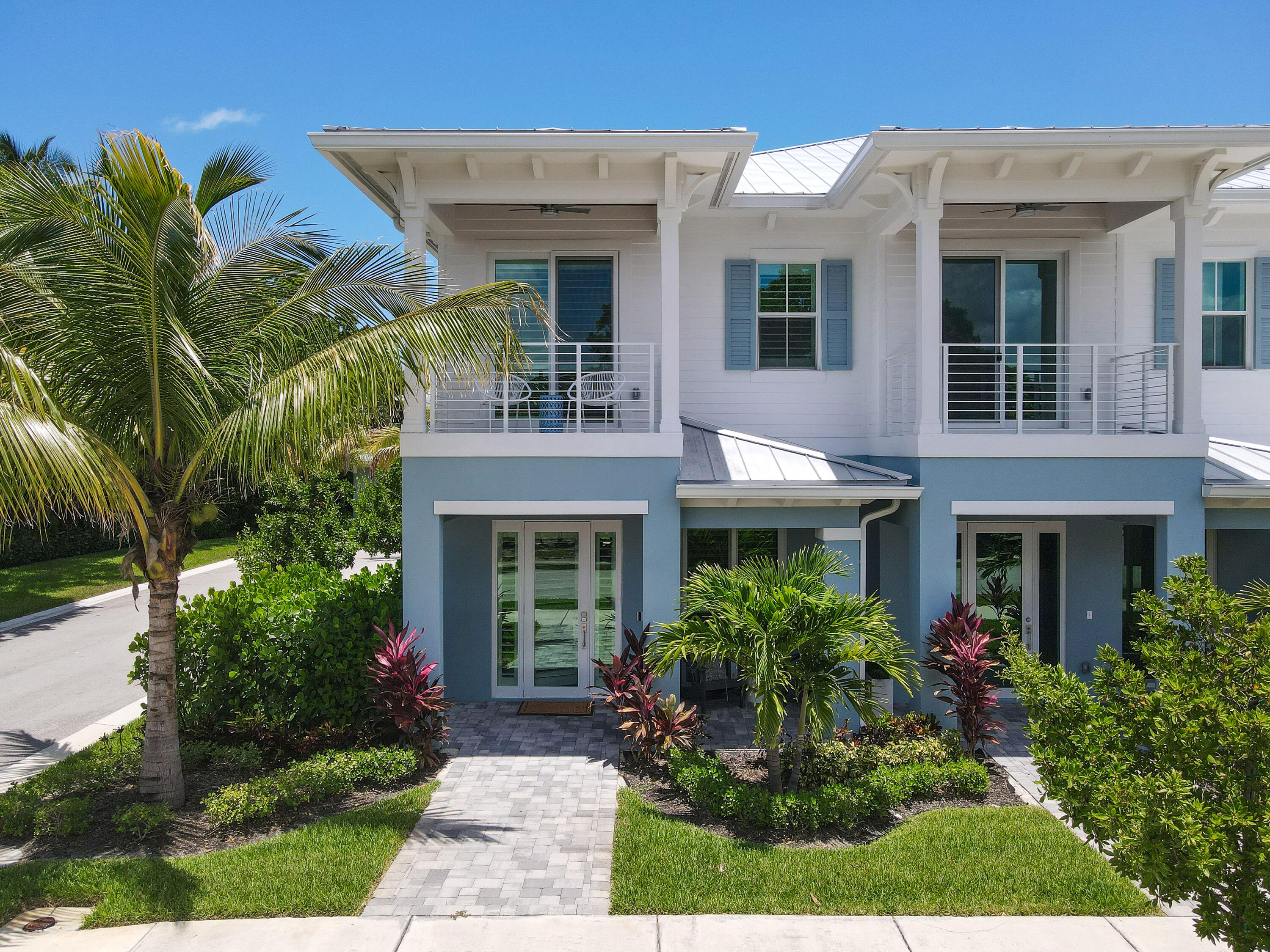 4650 Southeast Manatee Terrace Stuart, FL 34997 - Photo 59 of 95 a front view of a house with a yard and potted plants
