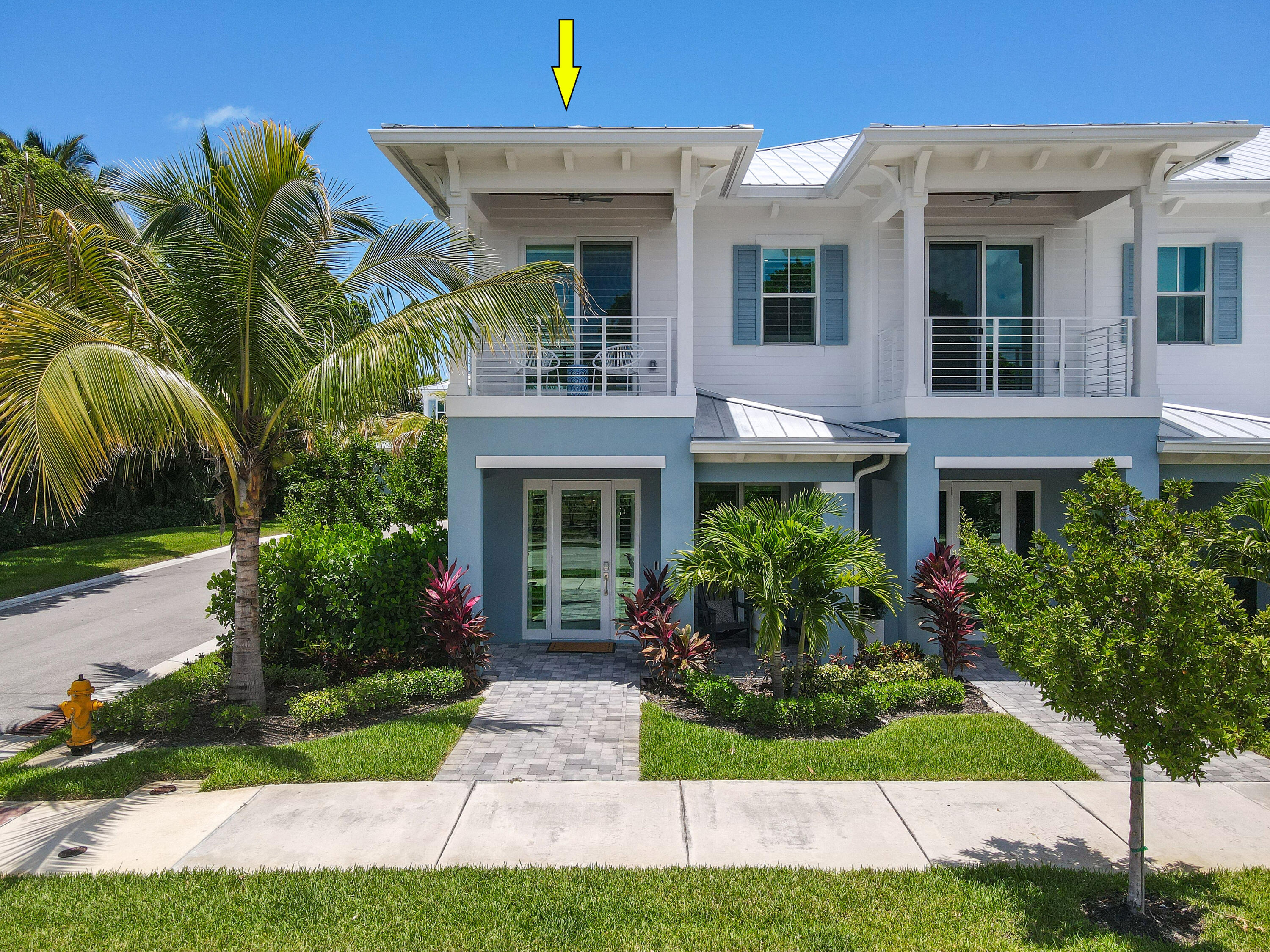 4650 Southeast Manatee Terrace Stuart, FL 34997 - Photo 61 of 95 a front view of a house with plants and garden