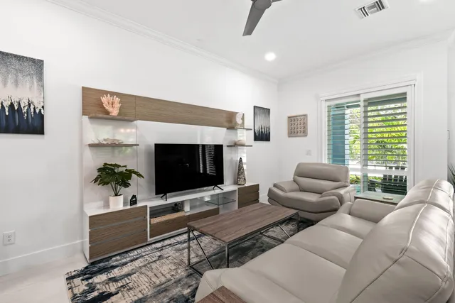 a living room with furniture a fireplace and a chandelier