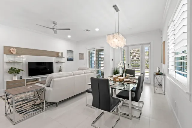 a kitchen with stainless steel appliances granite countertop white cabinets and a refrigerator