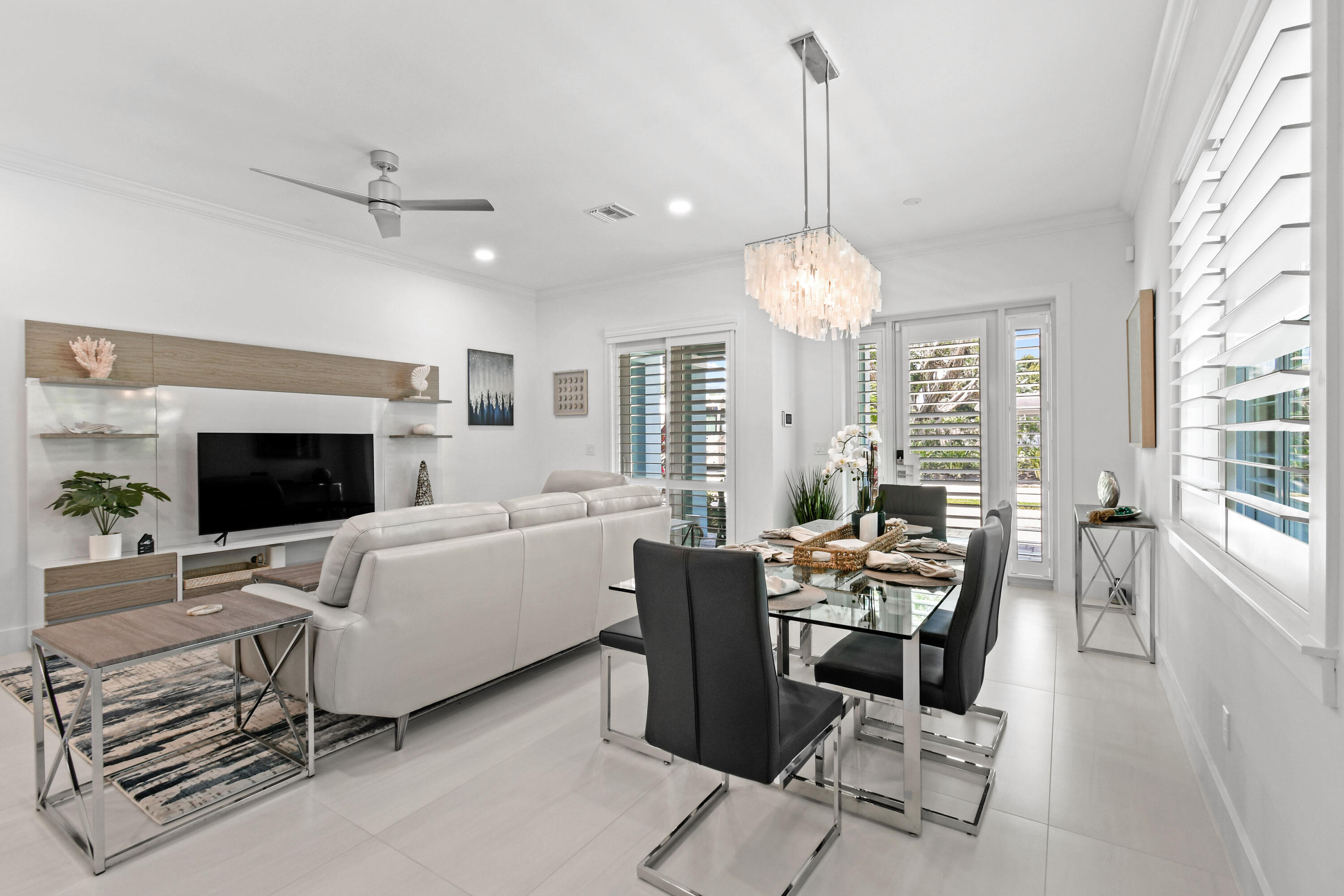 4650 Southeast Manatee Terrace Stuart, FL 34997 - Photo 9 of 95 a living room with furniture a fireplace and a chandelier