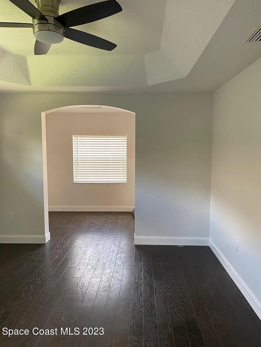 1913 Gloria Circle Palm Bay, FL 32905 - Photo 13 of 18 an empty room with wooden floor and windows