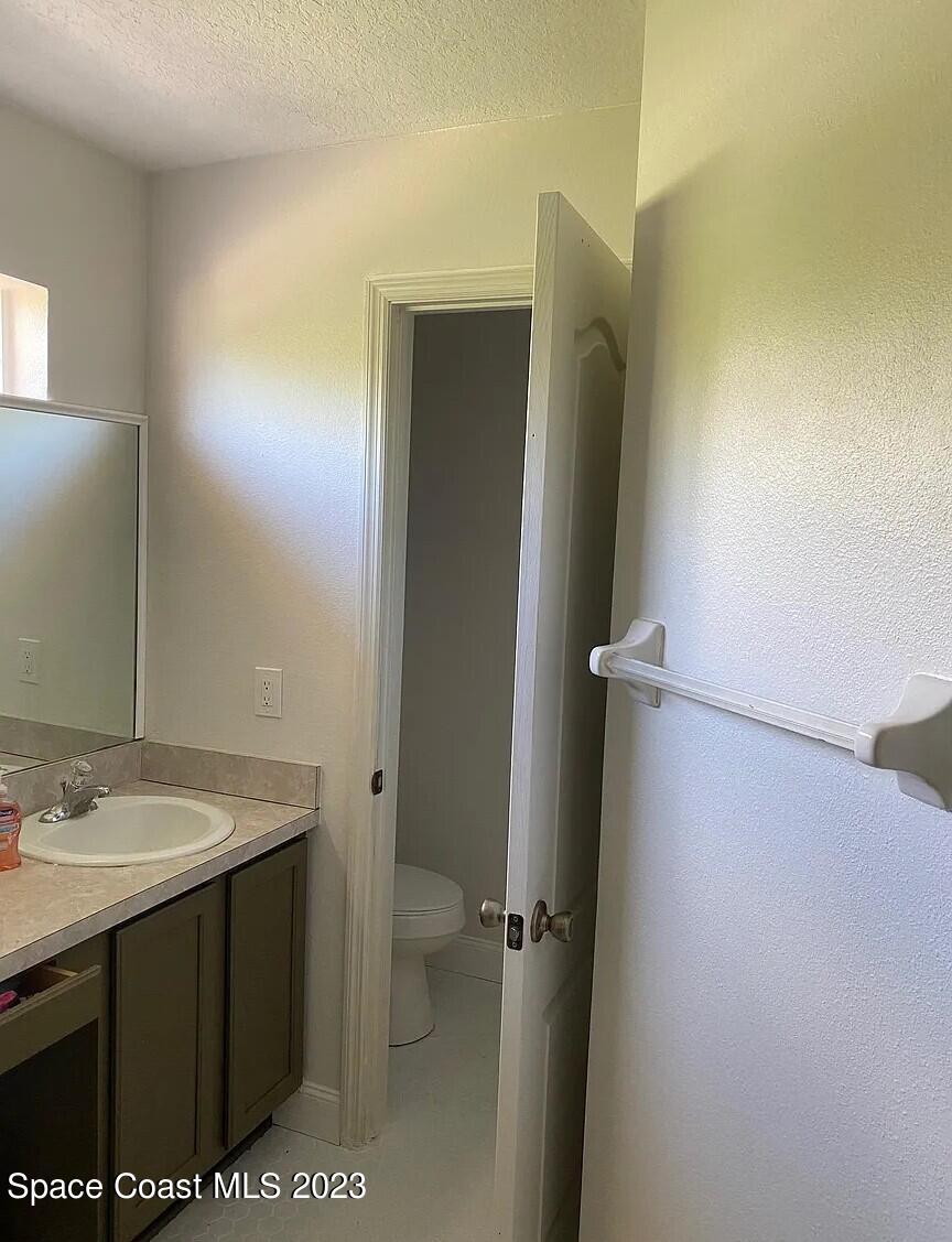 1913 Gloria Circle Palm Bay, FL 32905 - Photo 17 of 18 a bathroom with a sink a toilet and shower