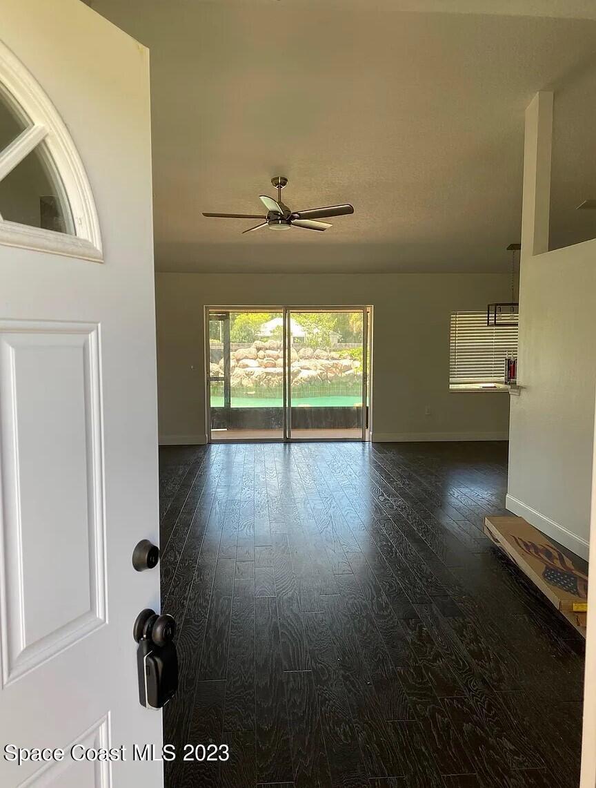 1913 Gloria Circle Palm Bay, FL 32905 - Photo 3 of 18 wooden floor in an empty room with a window