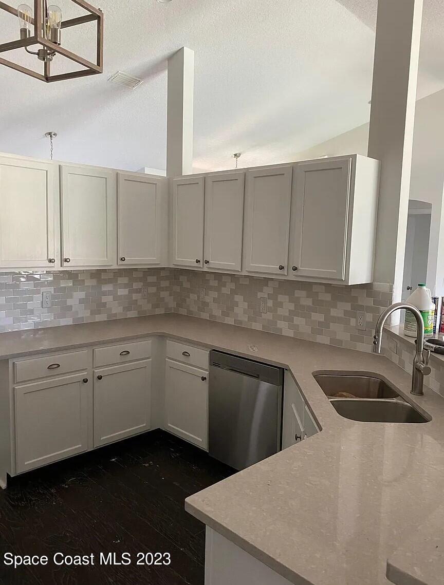 1913 Gloria Circle Palm Bay, FL 32905 - Photo 5 of 18 a kitchen with granite countertop a sink a stove and cabinets
