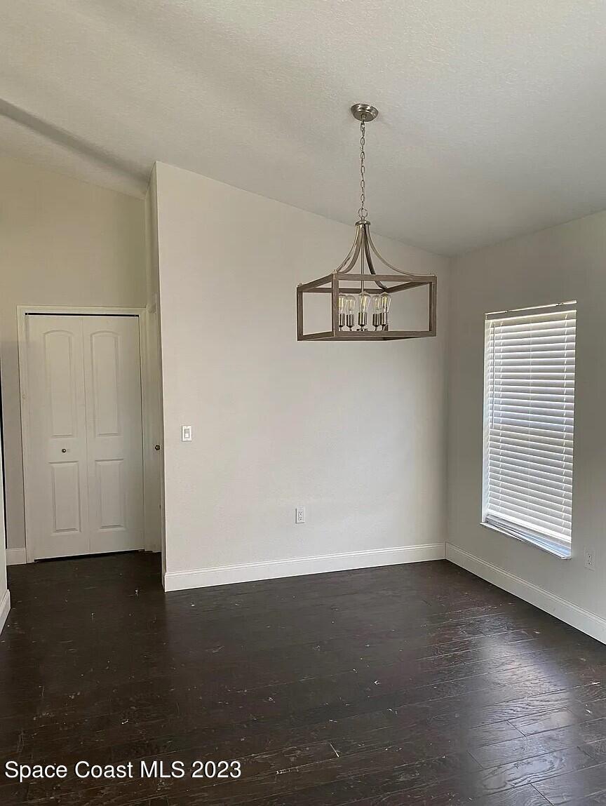 1913 Gloria Circle Palm Bay, FL 32905 - Photo 8 of 18 a view of a room with wooden floor and windows