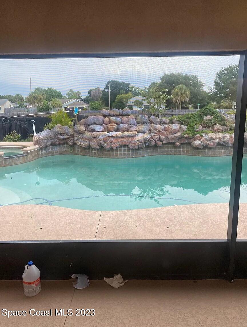 1913 Gloria Circle Palm Bay, FL 32905 - Photo 10 of 18 a view of a lake with a big yard