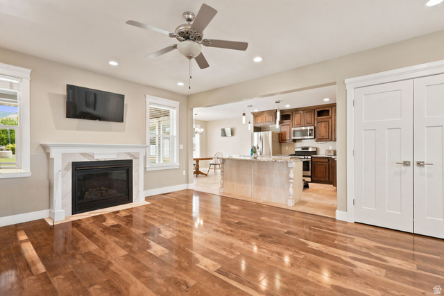 580 North 300 East Logan, UT 84321 - Photo 28 of 74 Open concept living area featuring wood-finish flooring, a fireplace with a white mantel, and recessed lighting